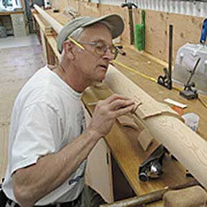 Bill Mills working on sloop Patience's mast